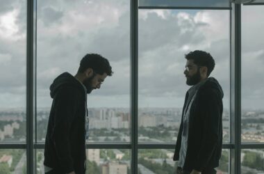 Two men standing in front of a window | Photo by cottonbro studio