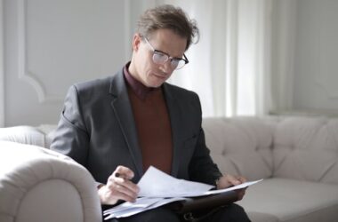 Lawyer reading through papers | Photo by Andrea Piacquadio