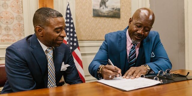 Man signing a contract | Photo by RDNE Stock project