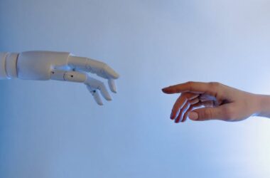 Person reaching out to robot | Photo by Tara Winstead