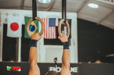 Gymnast in front of assorted flags | Photo by Victor Freitas from Pexels