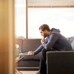 Man Using Laptop Sitting on Couch | Photo by LinkedIn Sales Navigator