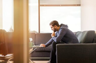 Man Using Laptop Sitting on Couch | Photo by LinkedIn Sales Navigator