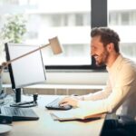 Man in White Dress Shirt Sitting on Black Rolling Chair While Facing Black Computer Set | Photo by Andrea Piacquadio